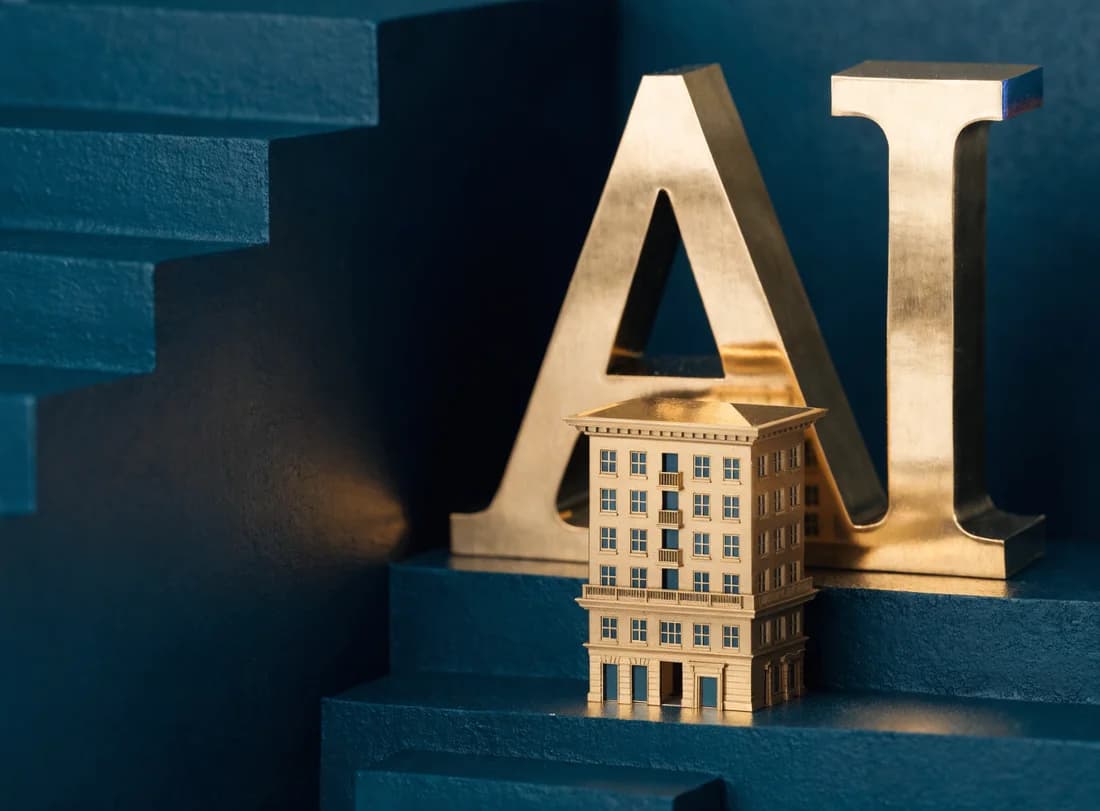 A miniature gold business building in front of large gold AI letters among dark teal architectural blocks.